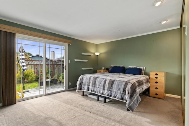 bedroom featuring ornamental molding, carpet floors, and access to outside