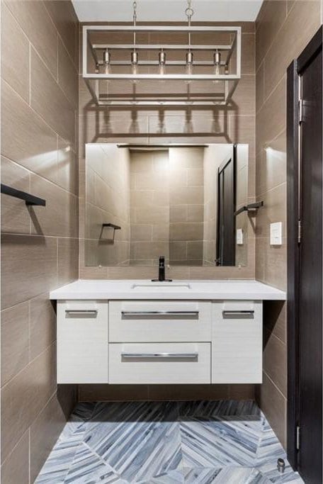 bathroom with vanity and tile walls