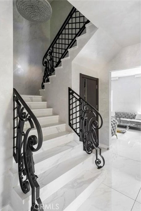 staircase with vaulted ceiling