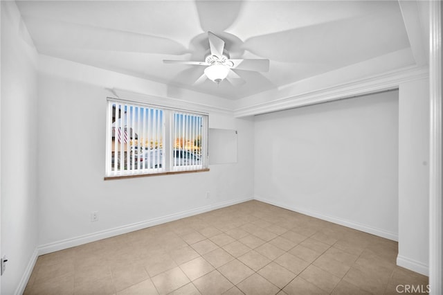 empty room with ceiling fan and light tile patterned floors