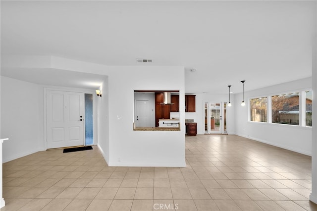 unfurnished living room featuring light tile patterned flooring