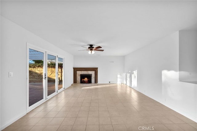 unfurnished living room featuring ceiling fan and a fireplace