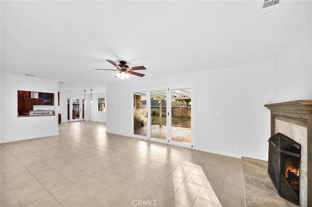 unfurnished living room featuring ceiling fan and light tile patterned floors