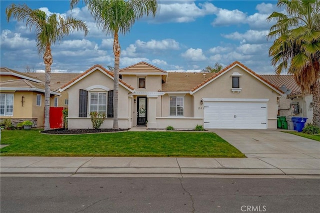 mediterranean / spanish-style home with a garage and a front yard