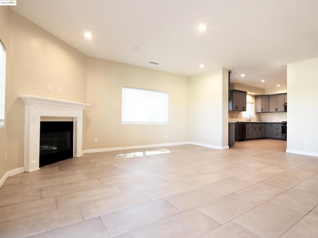 unfurnished living room featuring light tile patterned flooring