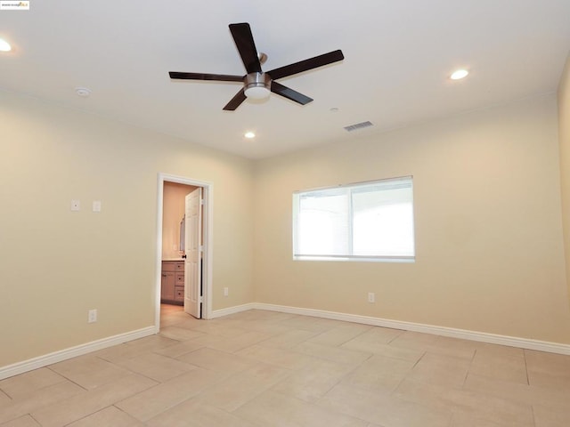 spare room with light tile patterned floors and ceiling fan