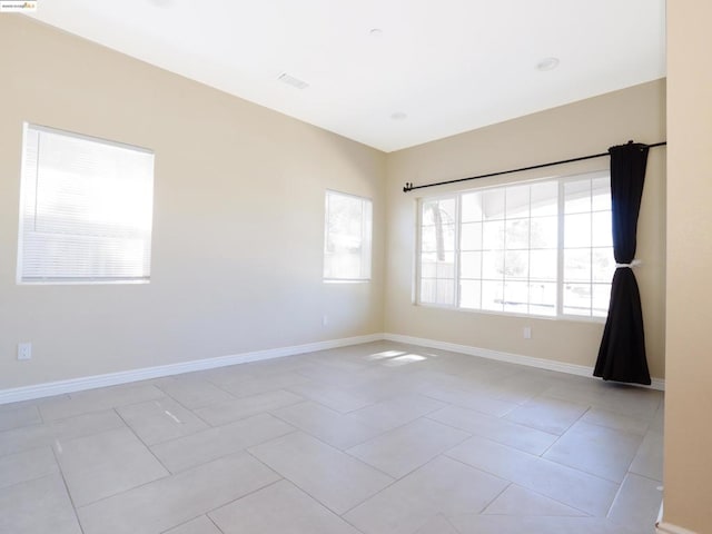 unfurnished room featuring light tile patterned floors