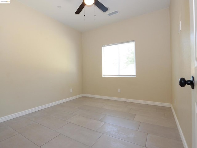 unfurnished room with ceiling fan and light tile patterned floors