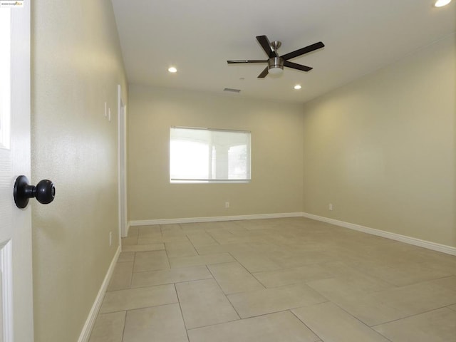 unfurnished room with light tile patterned floors and ceiling fan