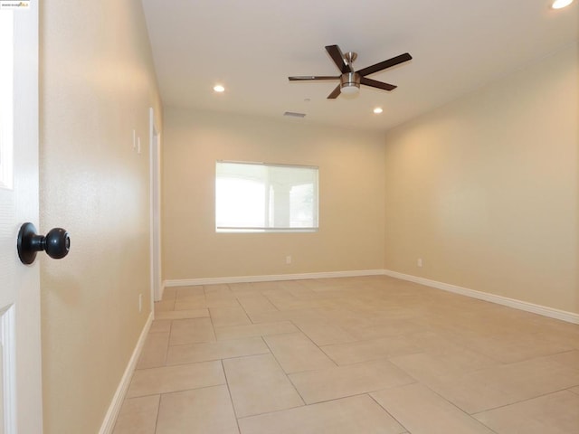 tiled empty room featuring ceiling fan