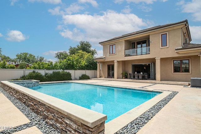 view of swimming pool featuring an in ground hot tub, a patio area, and cooling unit