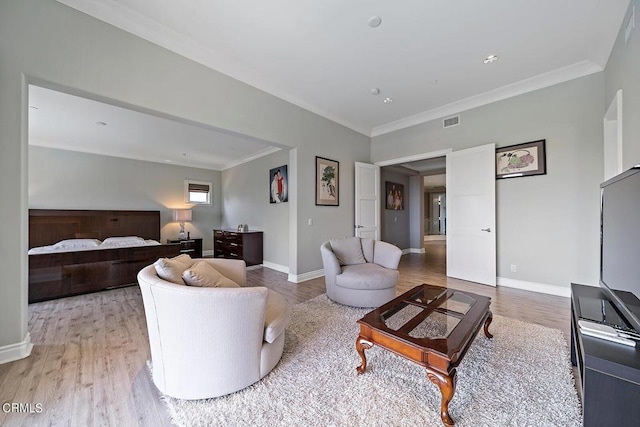 living room with crown molding and light wood-type flooring