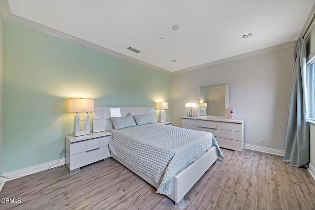 bedroom featuring crown molding and light wood-type flooring