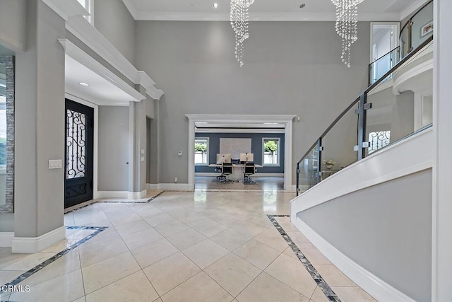 entryway featuring an inviting chandelier, ornamental molding, and light tile patterned flooring