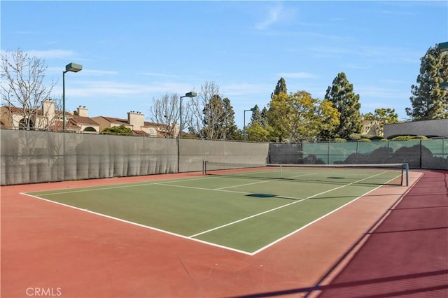 view of sport court featuring basketball hoop