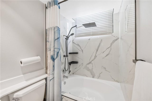 bathroom featuring shower / tub combo with curtain and toilet