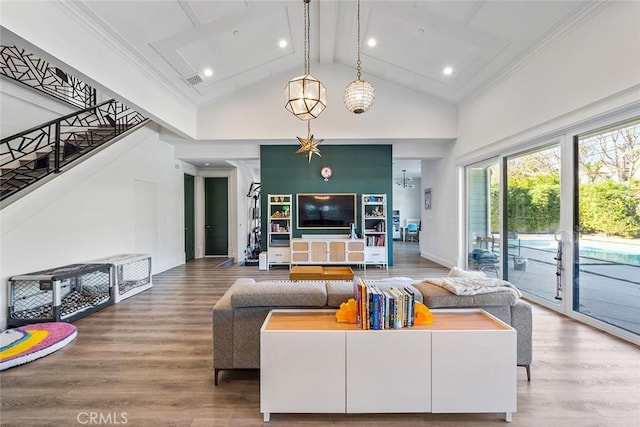 living room with hardwood / wood-style flooring, crown molding, and beam ceiling