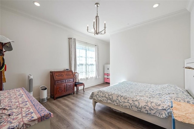 bedroom with wood-type flooring, ornamental molding, and a chandelier