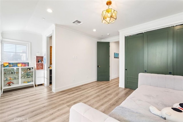 bedroom featuring ornamental molding, vaulted ceiling, and light hardwood / wood-style floors