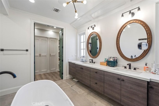 bathroom featuring vanity, a tub to relax in, and crown molding