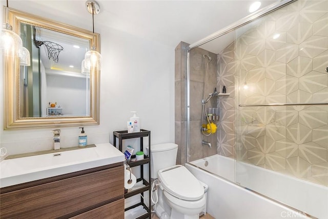 full bathroom with toilet, vanity, and shower / bath combination with glass door