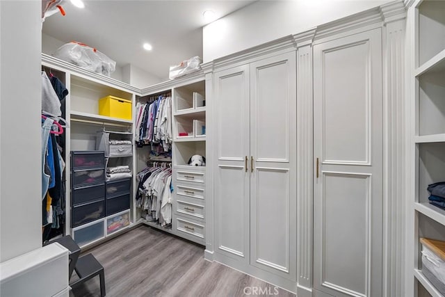 spacious closet with light hardwood / wood-style flooring