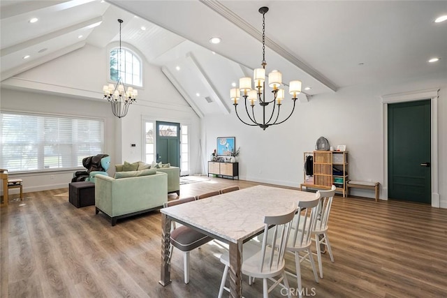 dining space with hardwood / wood-style flooring, high vaulted ceiling, a notable chandelier, and beam ceiling