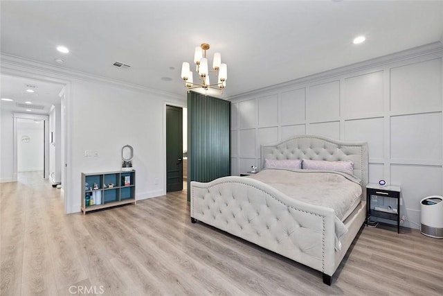 bedroom with an inviting chandelier, light hardwood / wood-style flooring, and ornamental molding