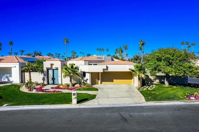 view of front of property with a front lawn and solar panels