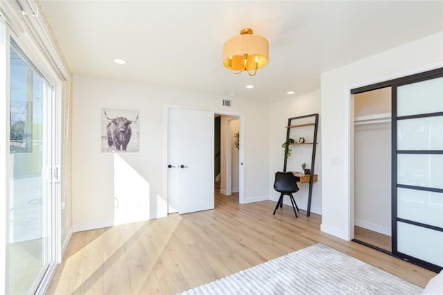 bedroom with a closet and light wood-type flooring