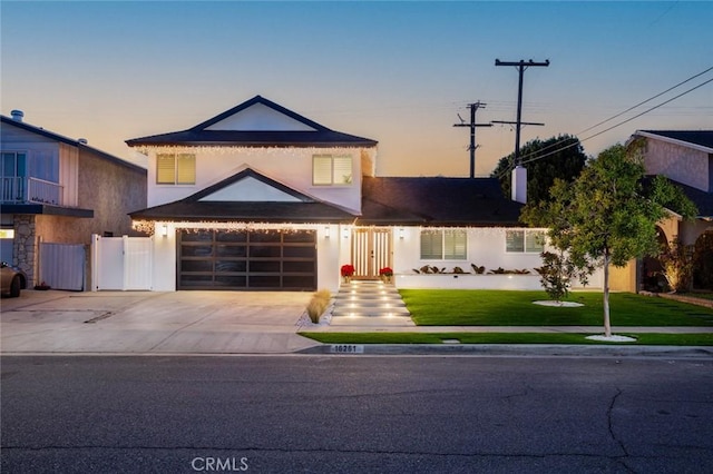 16261 Angler Ln, Huntington Beach, CA 92647 - view of front of home with a front lawn, driveway, a garage, and stucco siding
