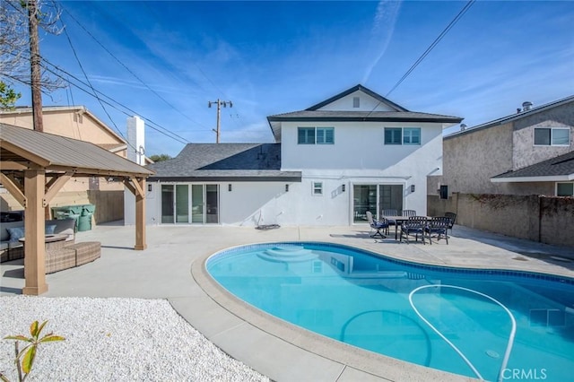 view of pool with an outdoor living space, a gazebo, and a patio