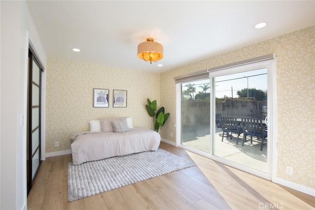 bedroom with hardwood / wood-style flooring and access to outside