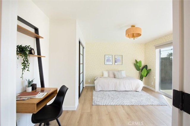 bedroom featuring access to exterior and light hardwood / wood-style floors