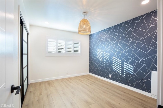 unfurnished bedroom featuring light hardwood / wood-style flooring and a closet