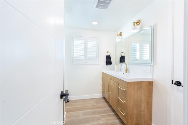 bathroom with vanity and hardwood / wood-style floors