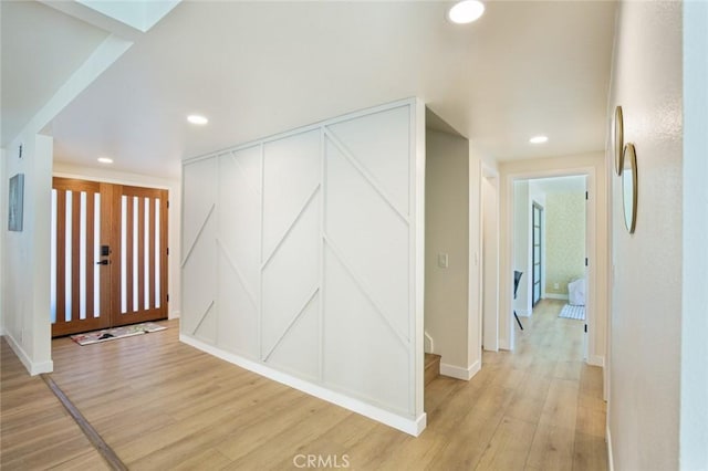 corridor with light wood-type flooring