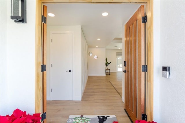 hall with light hardwood / wood-style floors