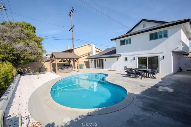 back of house featuring a gazebo, outdoor lounge area, and a patio area