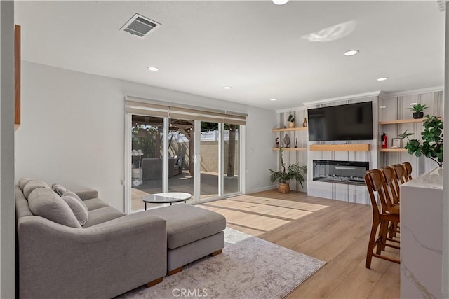 16261 Angler Ln, Huntington Beach, CA 92647 - living room featuring recessed lighting, wood finished floors, a glass covered fireplace, baseboards, and visible vents
