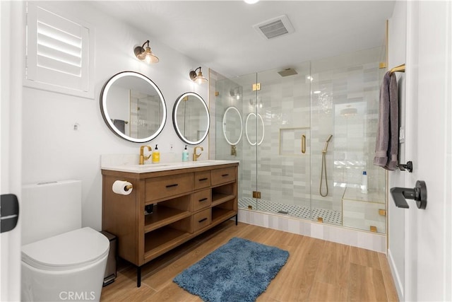 16261 Angler Ln, Huntington Beach, CA 92647 - bathroom featuring toilet, wood finished floors, visible vents, and a shower stall