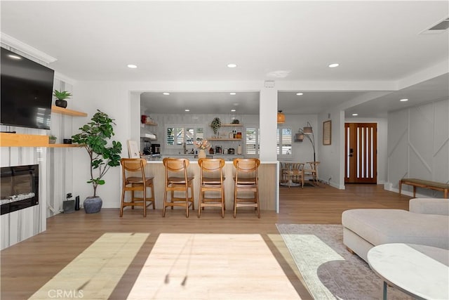 16261 Angler Ln, Huntington Beach, CA 92647 - living room with recessed lighting, wood finished floors, a fireplace, baseboards, and visible vents