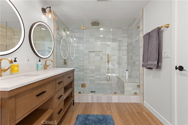16261 Angler Ln, Huntington Beach, CA 92647 - bathroom featuring double vanity, a sink, a shower stall, and wood finished floors