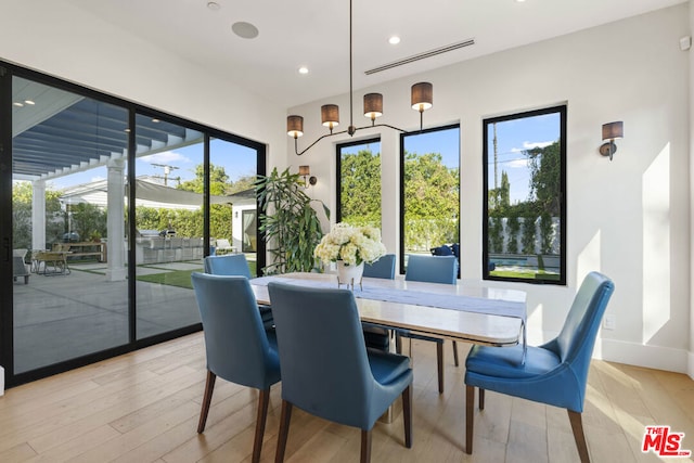 dining space with light hardwood / wood-style floors