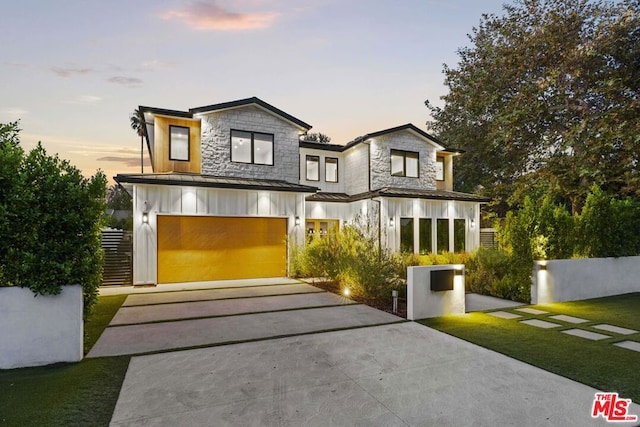 view of front of home featuring a garage and a yard