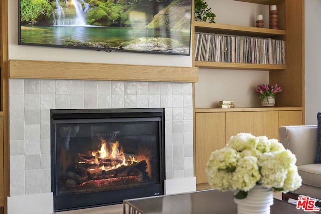 interior details with a tiled fireplace