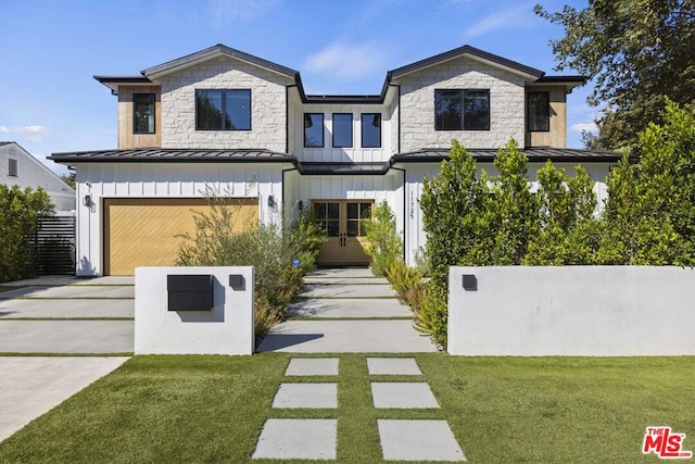 view of front of home featuring a garage and a front yard