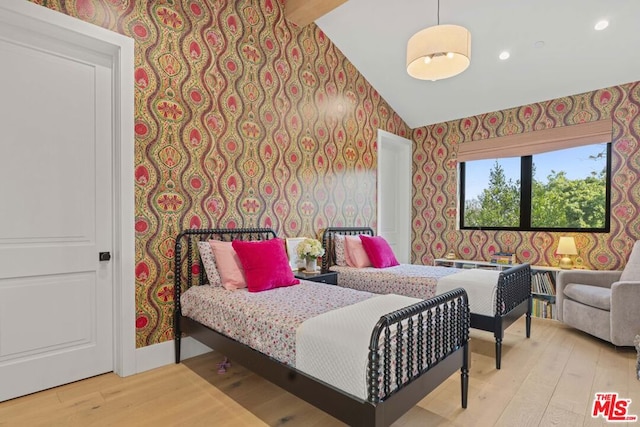 bedroom featuring lofted ceiling and light hardwood / wood-style floors