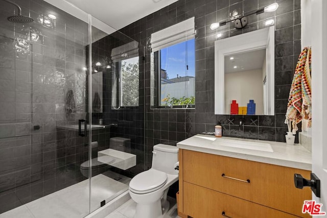 bathroom featuring a shower with door, tile walls, vanity, tasteful backsplash, and toilet