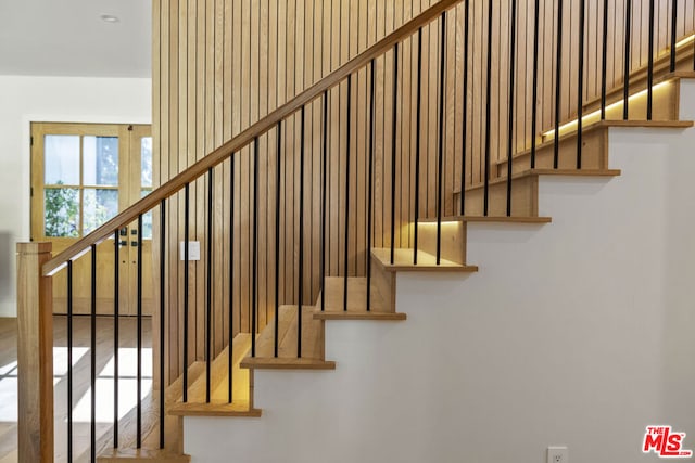 stairway with hardwood / wood-style flooring